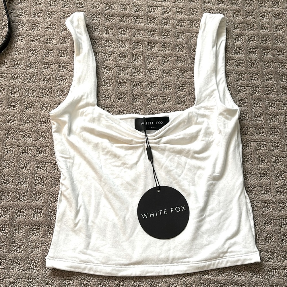 White fox taking off tank top